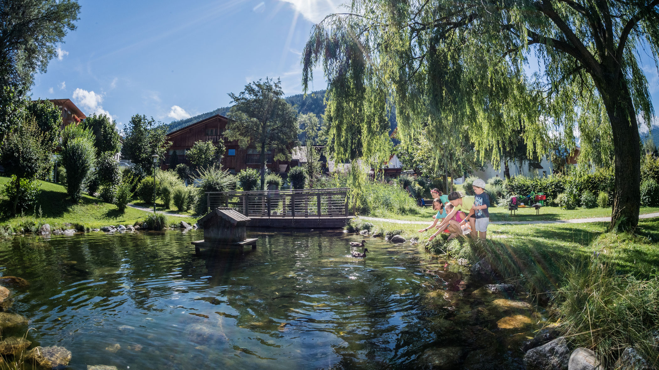 Children playing at the pond